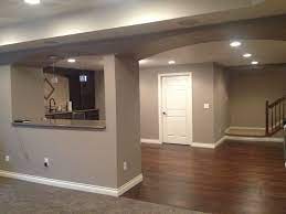 We painted the rooms yellow. Finished Basement Sherwin Williams Mega Griege Basement Wall Colors Basement Colors Modern Basement