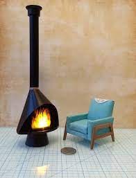 Sitting atop a vibrant yellow coffee table, you can sip your favorite drink and gaze out at the trees while enjoying the fire—picture perfect if you ask me. 1 12 Dollhouse Miniature Mid Century Modern Fireplace Mcm Black Fireplace Inspired By Malm Fireplace Retro Fireplace Modern Fireplace Malm Fireplace Black Fireplace