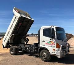 Dumper truck is unloading soil or sand at construction site. Load Guidelines Ballarat Sand Soil