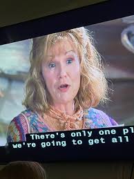 Me in my official Mrs. Weasley sweater, with my Weasley sweater wall in my  classroom.