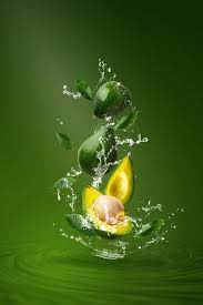 Water Splashing On Fresh Sliced Green Avocado Over Green Food Art Photography Fruit Photography Fruit Splash