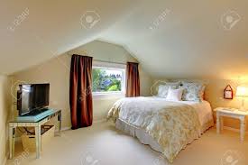 Coastal living separating rooms beach. Beige Attic Bedroom With Tv Brown Curtains And White Bed Stock Photo Picture And Royalty Free Image Image 28698395