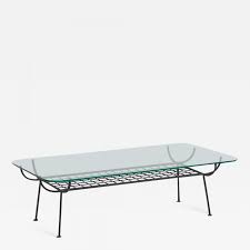 The rectangular design divides the table into a wide open shelf and closed housing for a single drawer that pulls out from the end. George Nelson Rare Wrought Iron Coffee Table With Glass Top By George Nelson For Arbuck
