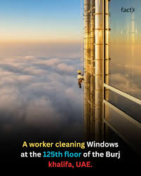 A worker cleaning windows at the 125th floor of the Burj Khalifa in the UAE is performing an awe-inspiring job at one of the world's tallest buildings. The breathtaking height and challenging