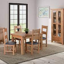 Made of solid wood and lacquered in an oak wood tone, this dining table is ideal for gathering the whole. This Small Extending Dining Table Is Part Of The Hardwick Light Oak Range