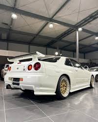 2000 Nissan Skyline GT-R This cool-looking gem comes in a Pearl White color,  a unique shade available in the later models. The 2000 R34 GT-R also  features a sleek black interior, adding