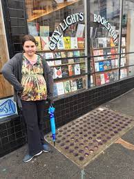 A Glowing Bank Of Round Purple Vault Lights In Front Of City Lights Bookstore In North Beach In San Francisco City Lights Bookstore North Beach City Lights