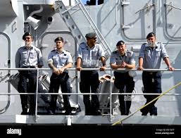 The delighted crew of BNS Louise-Marie, as they are greeted by onlookers  from the quarter deck of HMS Belfast Stock Photo