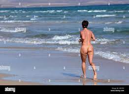 Nudist woman jogging on the beach. Canary Island Fuerteventura, Spain Stock  Photo - Alamy