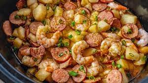 Crockpot Cajun Style Smothered Sausage Potatoes And Shrimp Recipe Recipe Smothered Potatoes Crockpot Recipes Slow Cooker Sausage Crockpot