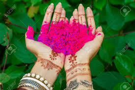 Henna paste is moist when applied. Beautiful Woman Hold In Hands With Henna Tattoo And Bracelets Jewelry Colorful Pink Violet Holi Dust Powder Paint Happy Traditional Indian Wedding Holiday Summer Culture Festival Concept Green Leaves Stock Photo Picture