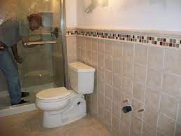 White tiles can really open up a room, with black grouting and accessories adding a bit of depth and style to your interior. Accent Tile Outside Of Shower Small Bathroom Tiles Bathroom Tile Designs Simple Bathroom Designs