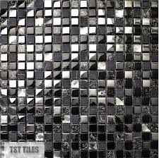 The backsplash contains black, rectangular glass tiles that come in various sizes, from small to large. Stone Glass Tile Dark Blue Gray Black Silver Italy Mosaic Kitchen Tiles Bathroom Mirror Tile Backsplash Wall Sticker Decor Tile Bathroom Mirror Tile Stone Glass Tileglass Tile Aliexpress