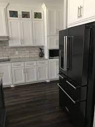 Unique designs incorporate stainless and wood for the finest kitchens offered in the world Black Stainless Kitchenaid Appliances White Cabinets White Cabinets Black Appliances Black Appliances Kitchen Appliances White Cabinets