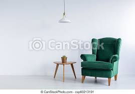 All green chairs can be shipped to you at home. Cozy Emerald Green Wing Armchair And A Cactus On A Wooden Table In A White Living Room Interior With Copy Space Real Photo Canstock