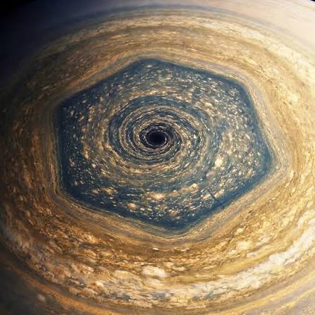 saturn's north pole the hexagon is nearly 30,000 km (20,000 miles) wide.  this is large enough that two earths could fit inside the storm with room  to spare. it is a standing