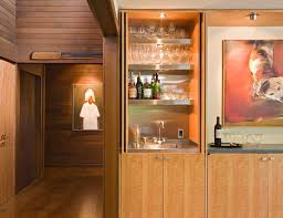 While you dream of one day designing a home bar with seating for all your friends, for now you're stuck with an apartment barely big enough for you and all your shoes. How To Squeeze In A Home Bar Even In The Smallest Homes