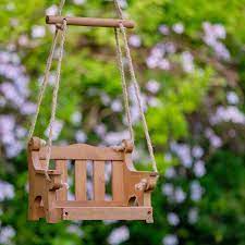 The tray is made of a recycled plastic composite material, textured to look like wood. Swing Seat Bird Feeder Wildlife World