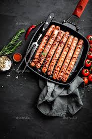 Grilled Sausages Bratwurst In Grill Frying Pan On Black Background Top View Grilled Sausage Bratwurst Grilling