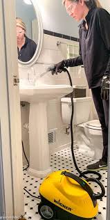 a steam cleaner to clean a bathroom