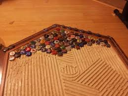 The glue bonds very well to wood. Diy Beer Cap Table Beer Cap Table Beer Cap Crafts Diy Beer