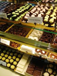 chocolates in a display case | Chocolate shop, Chocolate lovers, Chocolate