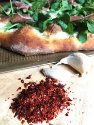 Women gather around a big flat tray, flat the vine leave on the tray, put a little bit of rice which mixed with black pepper & touch of salt. Aleppo Pepper Adventure Kitchen