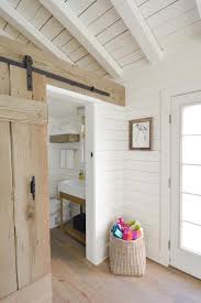 Barn Door In A White Cottage Cottage Interiors White Wood Paneling Rustic Barn Door