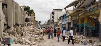 People look at damaged buildings in jeremie, haiti, after a 7.2 magnitude . Haiti Receives Advice From Un Economists On Attracting Foreign Investment Un News