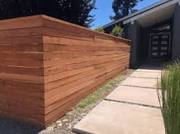 For gentle slopes, a privacy fence can be built along the contour. Redwood Fencing Style Choices From A And J Fencing