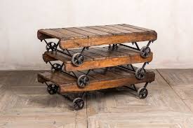 Spacious tabletop and shelf store and display trinkets, board games, and conversation starters. Industrial Style Coffee Table With Wheels Peppermill Interiors