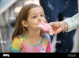 Child eating cotton candy Stock Photo