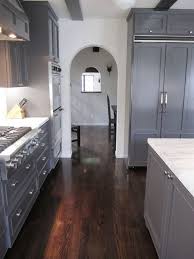 An application of ceramic floor tile here makes it looks like made of hardwood material. Grey Kitchen Cabinets Dark Floor Our Own Home Pinterest White Cabinets Kitchen Dark Floors Dark Grey Kitchen Grey Flooring