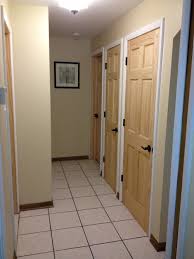 White doors, dark stained wood trim, and creamy white paint for elegance. Oak Door With White Trim