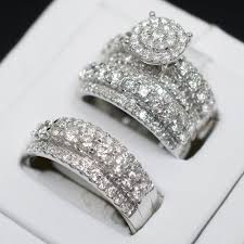 A trio ring set includes a lady's engagement ring and wedding band as well as a men's wedding band. Diamond Trio Set His Her Matching Engagement Wedding Ring 10k White Gold Finish Cool Wedding Rings Wedding Ring Bands Set Engagement Wedding Ring Sets