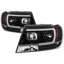 spyder auto jeep grand cherokee 99 04 version 2 light bar projector headlights black 5085221 the home depot spyder auto jeep grand cherokee 99 04 version 2 light bar projector headlights black