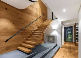 The wooden stairs sans any handrails on one side appear open and are hardly felt consuming space, the space below it has been converted to the media corners. Stairs With Exclusive Designs Featuring Mafi Natural Wood Floors