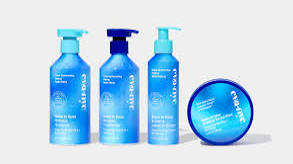 Eva NYC Brass to Sass Purple Shampoo & Conditioner bottle close-up