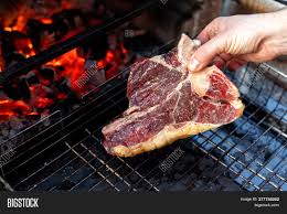 How to grill a t bone or porterhouse steak a tutorial 101 cooking for two from www.101cookingfortwo.com when cooking with a charcoal grill, build a two level fire by stacking most of the coals on one side and the remaining coals in a. Close Man Hand Image Photo Free Trial Bigstock
