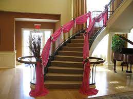 28 fabulous stairway decorating ideas to add style to unexpected places while a staircase is often a design feature in and of itself, the right decorating can transform it into an editorial spread right out of your favorite home interiors magazine. This Staircase With Its Elegant Pink Fabric Swags Provided The Ulitmate Backdrop For The Quinceanera Girl S Entourage Stair Decor Staircase Decor Wedding Staircase Decoration