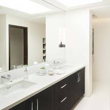 The size of bathroom mirrors is entirely dependent on style, proportion, and personal preference. Ceiling Height Bathroom Mirror Design Ideas