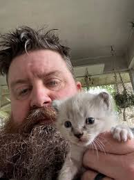 I got hold the little possum looking one. I was wrong, they're about 3  weeks old. Mary Margaret has decided it's cool if we hold them now.