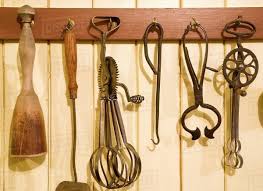 antique kitchen utensils hanging from