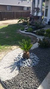 Home Landscape With Black Lava Rocks And Earth Tone Rocks Landscaping With Rocks River Rock Landscaping Rock Garden Landscaping