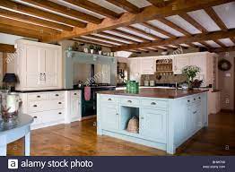 The gorgeous marble top kitchen island in a white finish provides the ultimate in style and function to dress up your kitchen. Pastel Blue Island Unit In Large Cream Country Kitchen With Beamed Ceiling Stock Photo Country Kitchen Cream Country Kitchen Country Kitchen Island