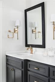 Black And Gold Bathroom Vanity Black Bath Vanity With Gold Faucet Compliments A Gold Sconce Next To A Black Lattice Mirror Charcoal Bathroom Bathroom Vanity Bathroom Cabinets Designs