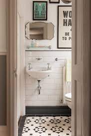 Interior design firm robson rak embraced the small size of this powder room by making it feel snug and intimate with black tiles, mood lighting, and dark cabinets under the smoky natural stone sink. Pin By Kaya Jill On Bathrooms Bathroom Tile Designs Bathroom Inspiration Small Bathroom