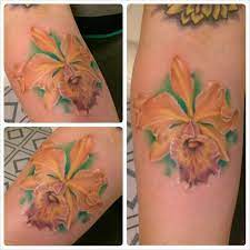 Orchid Tattoo This Orange Beauty Has A Splash Of Purple To Add Some Jazz It Was Also Free To One Of Our Essay Contest Winn Orchid Tattoo Tattoos Leaf Tattoos