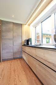 kitchen with milled led lighting above the window concrete look combined with wood decor and black natural stone countertop home decor stone countertops kitchen bedroom lighting diy natural stone countertops