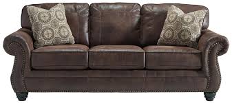 By star home living (3) $ 1443 05. Benchcraft Breville Faux Leather Sofa With Rolled Arms And Nailhead Trim Wayside Furniture Sofas